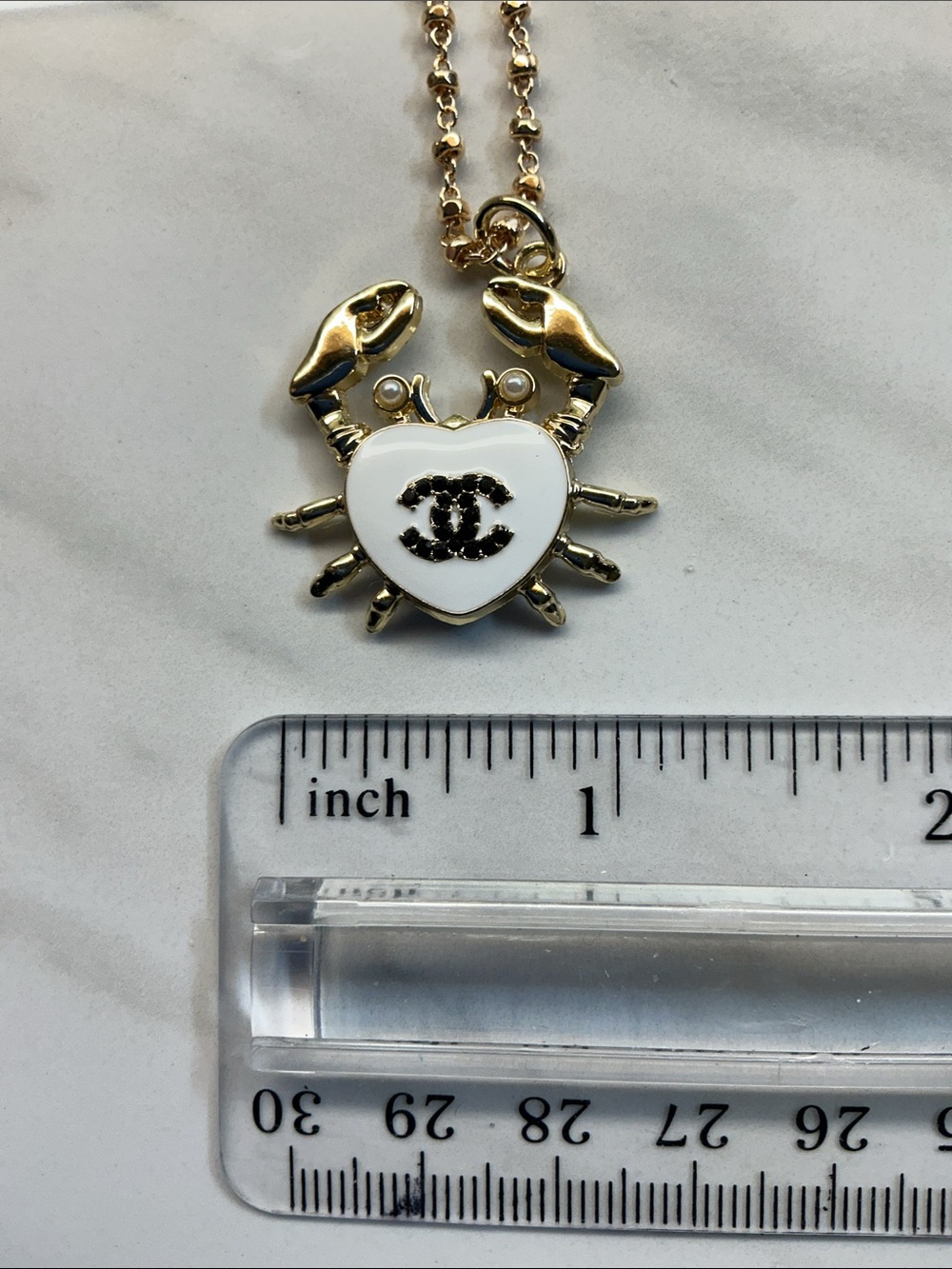 Gold-Tone Crab Pendant Necklace with White Enamel Heart and Black Logo - Picture 5 of 7